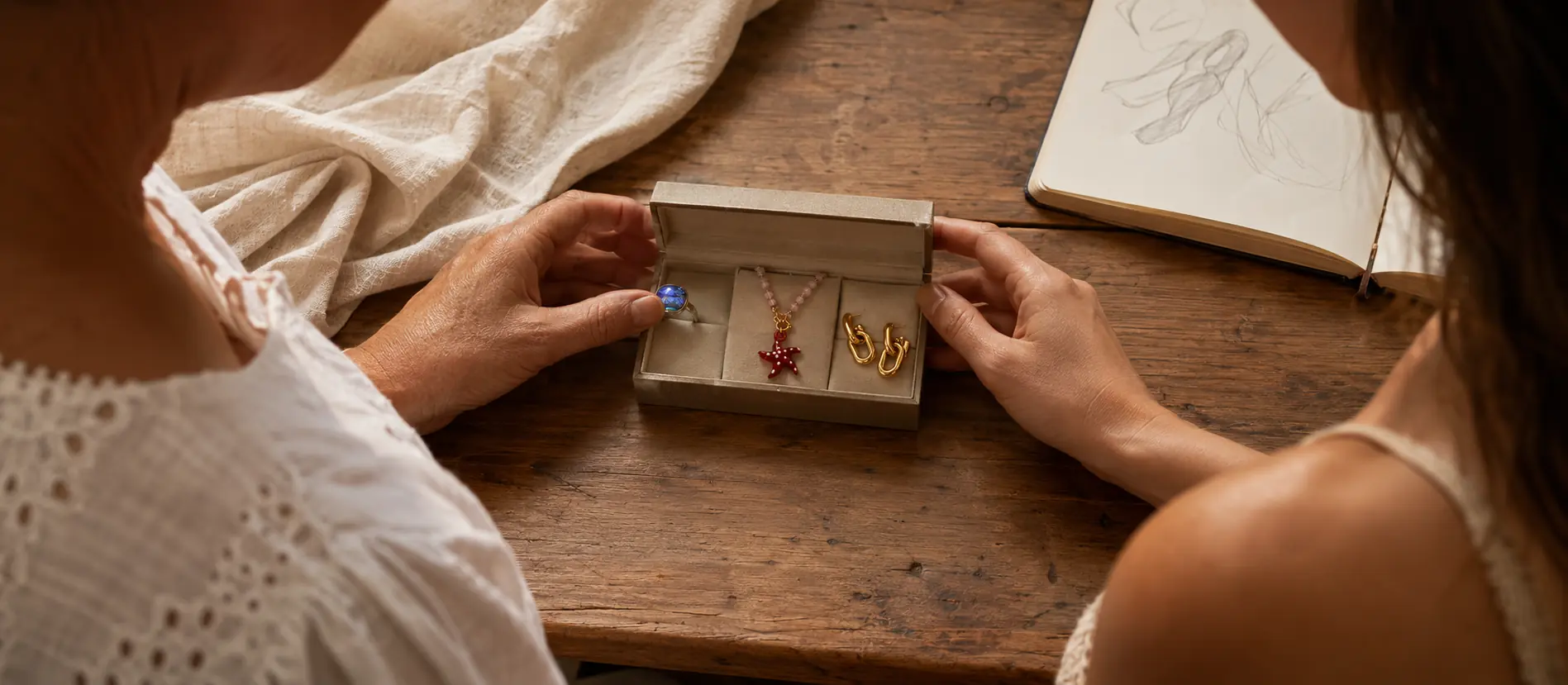 Two generations looking through a family jewelry box